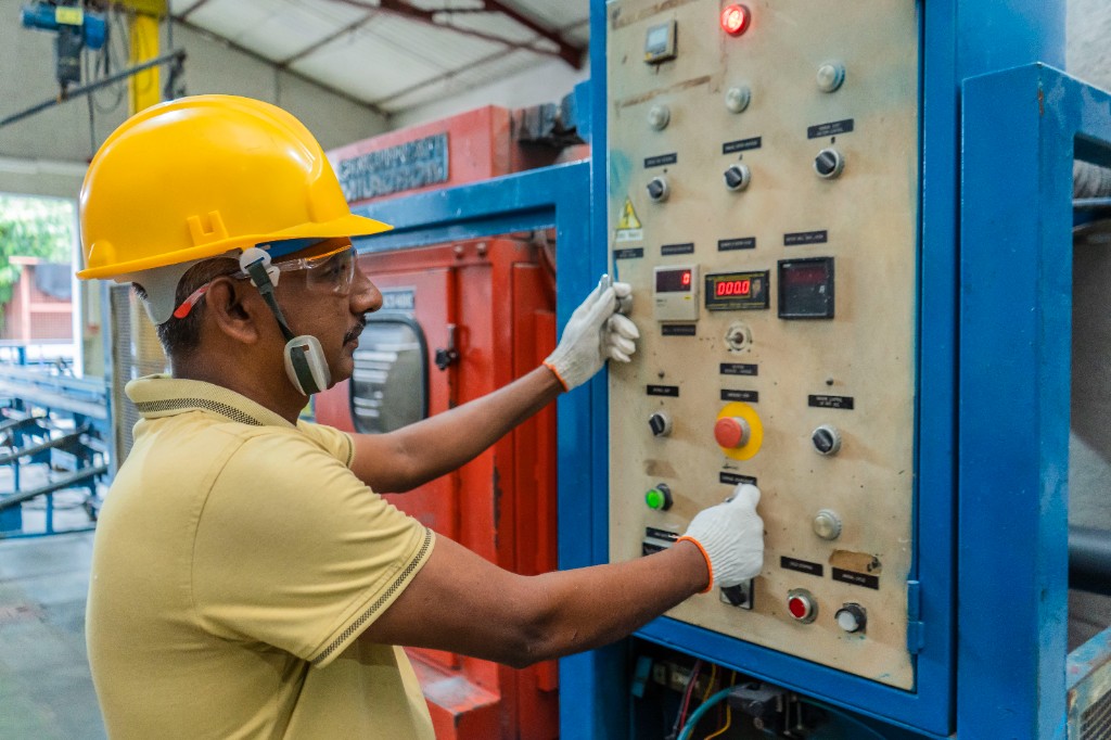 National PVC manufacturing team member operating machinery